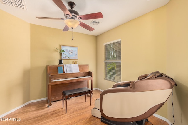 sitting room featuring ceiling fan and light hardwood / wood-style floors