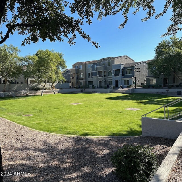 view of property's community with a lawn