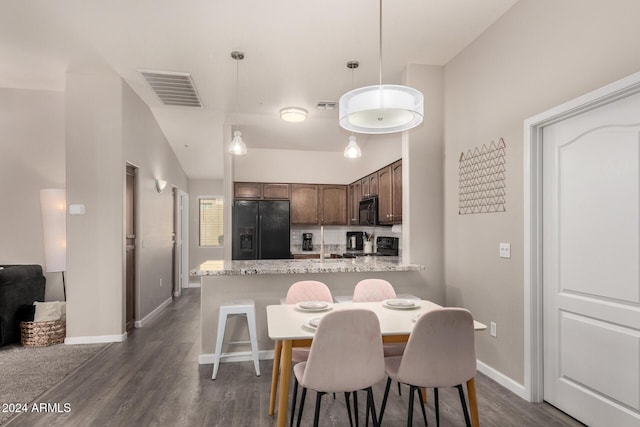 dining area with dark hardwood / wood-style flooring