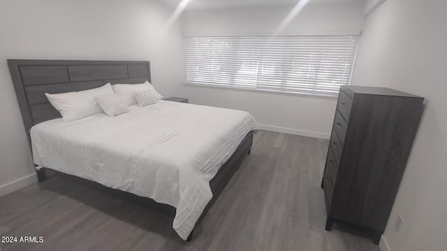 bedroom with dark wood-type flooring