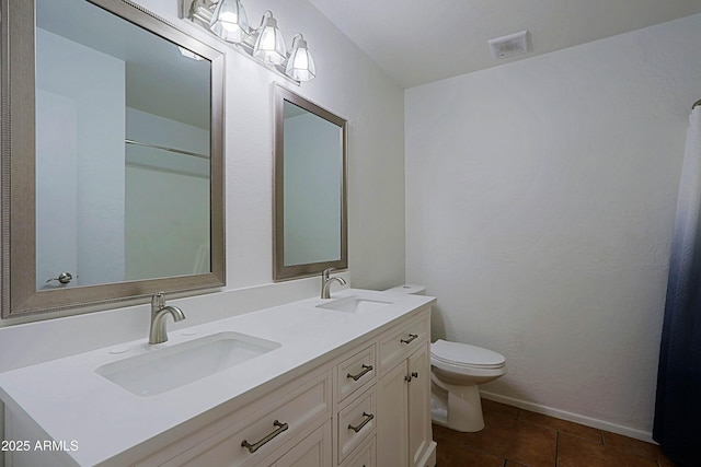 3054 W Redfield Rd, Phoenix, AZ 85053 - bathroom featuring double vanity, toilet, and tile patterned flooring