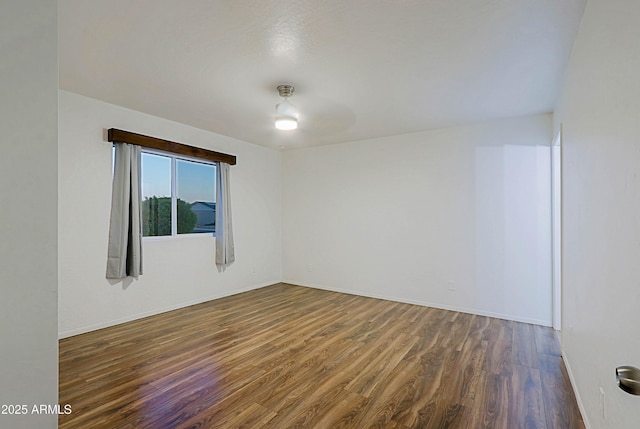 3054 W Redfield Rd, Phoenix, AZ 85053 - spare room with dark wood-style flooring and baseboards