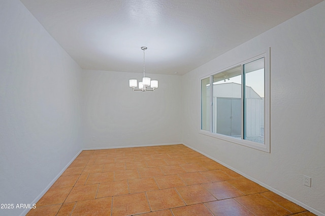 3054 W Redfield Rd, Phoenix, AZ 85053 - empty room with a chandelier, baseboards, and light tile patterned flooring