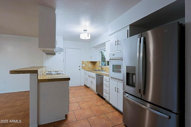 3054 W Redfield Rd, Phoenix, AZ 85053 - kitchen with stainless steel appliances, a sink, and white cabinetry
