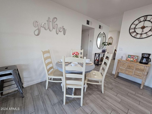 dining area featuring hardwood / wood-style flooring and heating unit