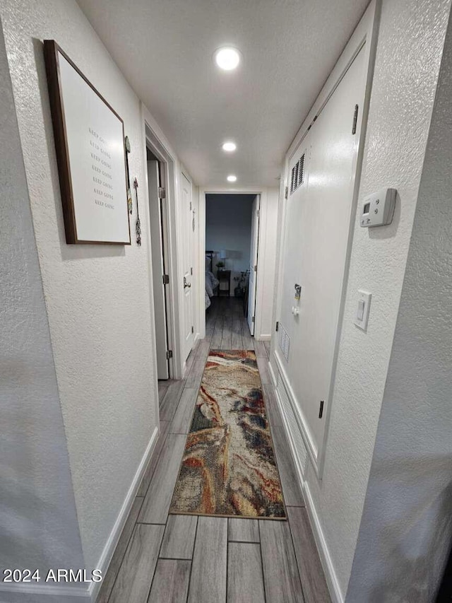 hallway with light wood-type flooring