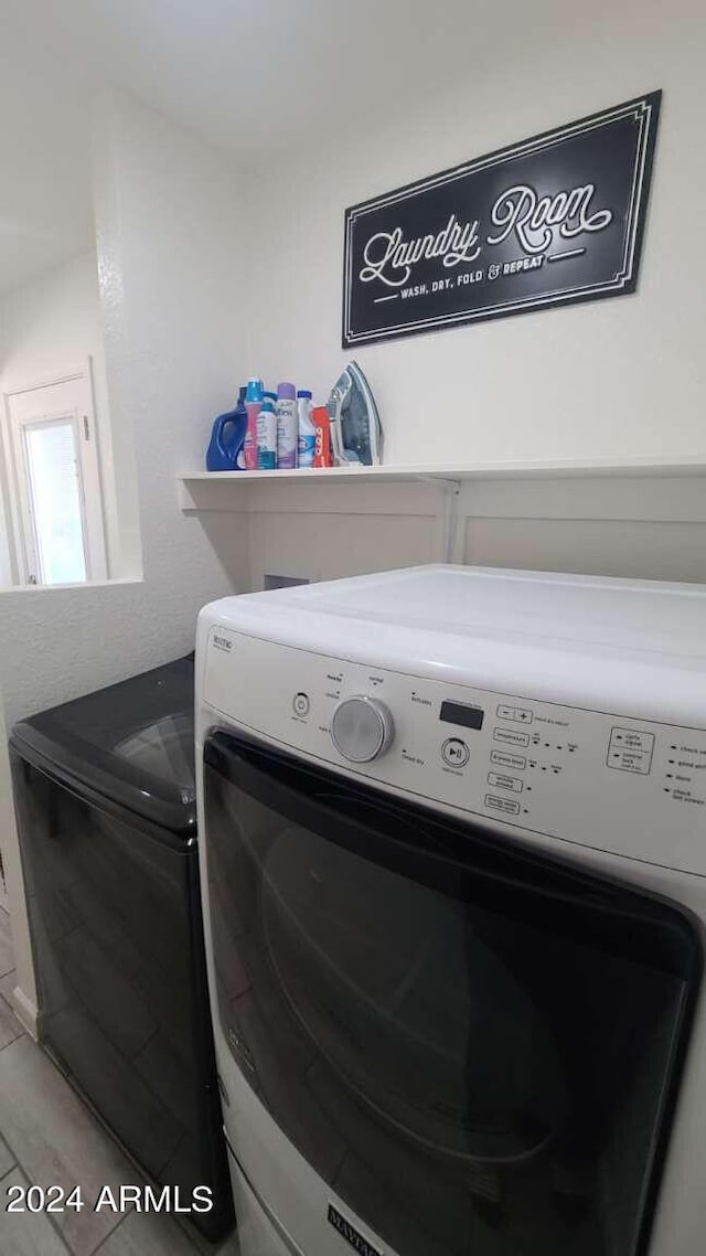 laundry area with washing machine and clothes dryer