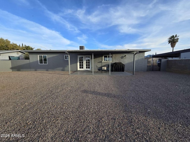 rear view of house featuring a patio area and french doors