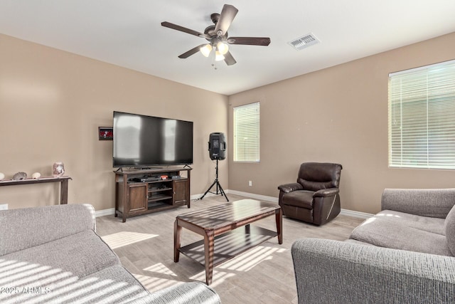 living room with ceiling fan and light hardwood / wood-style floors