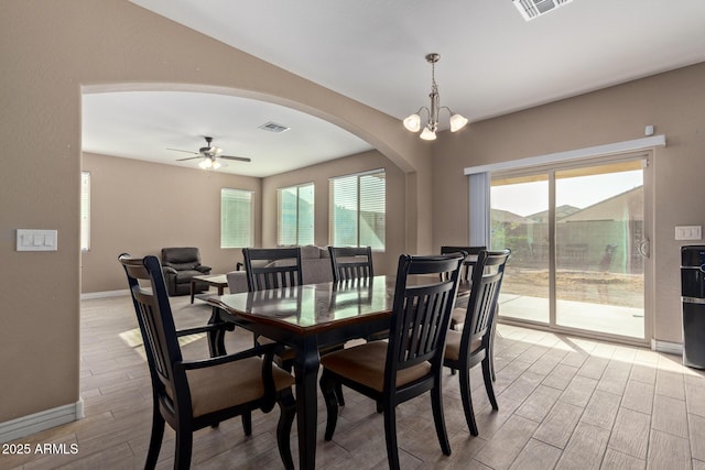 dining room featuring ceiling fan with notable chandelier