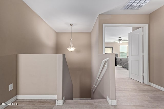 staircase with hardwood / wood-style flooring and ceiling fan