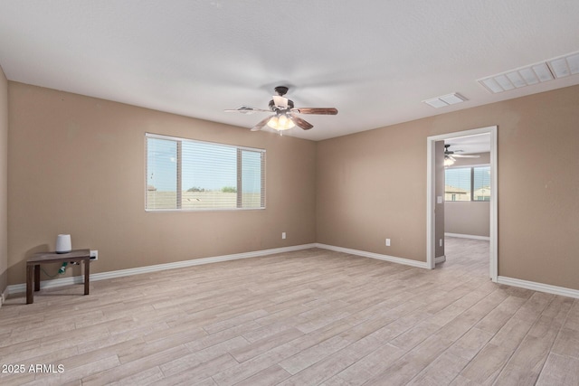 unfurnished room featuring ceiling fan and light wood-type flooring