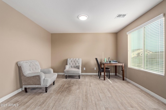 sitting room featuring light hardwood / wood-style floors and a healthy amount of sunlight