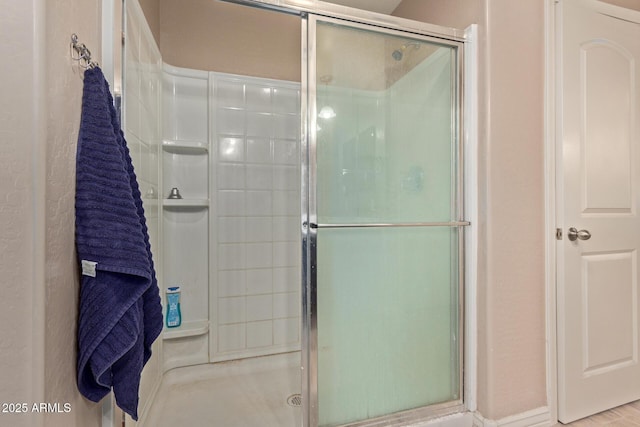 bathroom with a shower with shower door