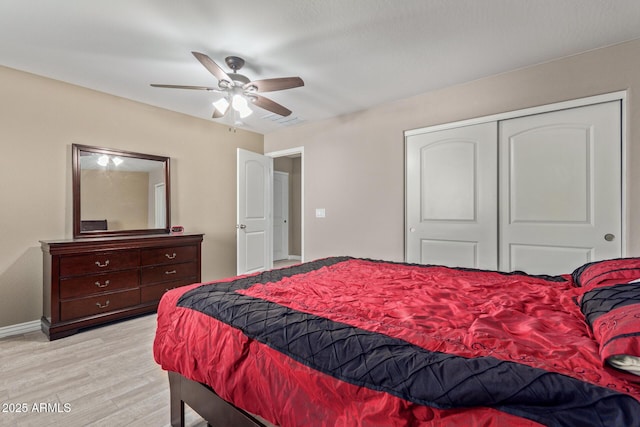 bedroom featuring a closet, light hardwood / wood-style flooring, and ceiling fan