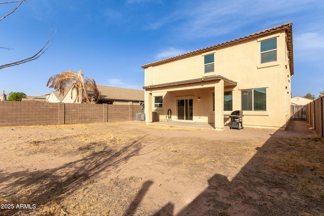 rear view of property with a patio and central AC unit