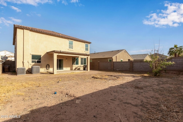 rear view of property featuring a patio and central AC unit