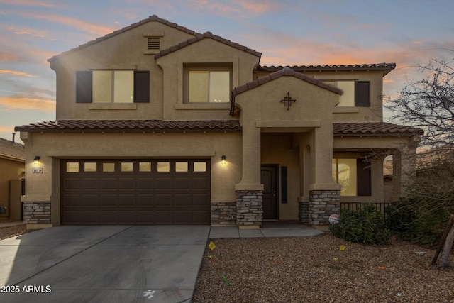 mediterranean / spanish-style home with a garage