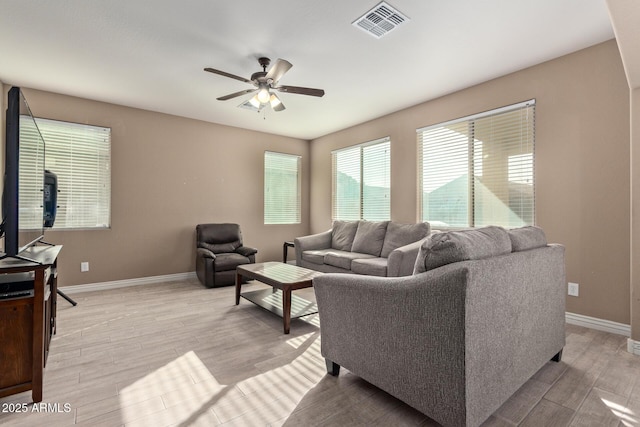 living room with light wood-type flooring and ceiling fan