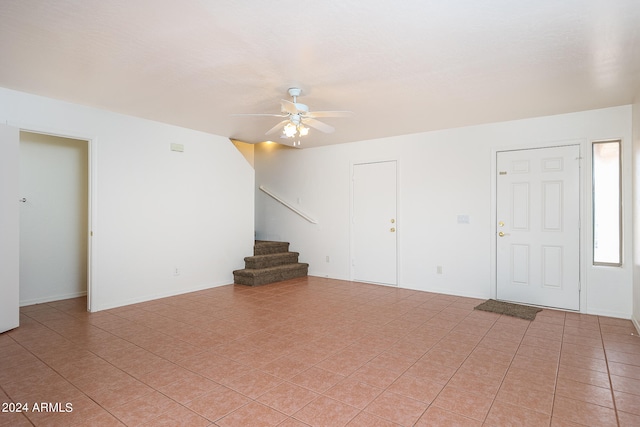 interior space featuring ceiling fan and light tile patterned floors