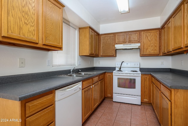 kitchen featuring white appliances, sink, and light tile patterned floors