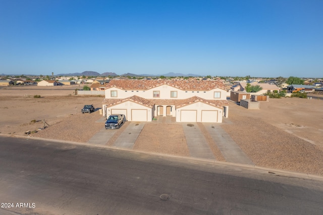 view of front of property featuring a mountain view and a garage