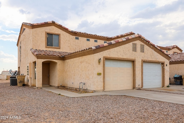 mediterranean / spanish-style house with a garage