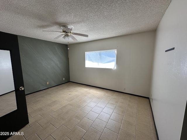 220 S Old Litchfield Rd Unit 104, Litchfield Park, AZ 85340 - empty room with a ceiling fan, a textured ceiling, and tile patterned floors