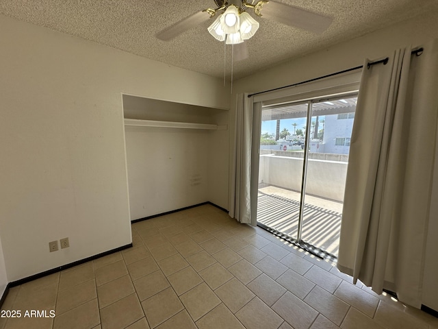 220 S Old Litchfield Rd Unit 104, Litchfield Park, AZ 85340 - spare room featuring a textured ceiling, a ceiling fan, and light tile patterned floors