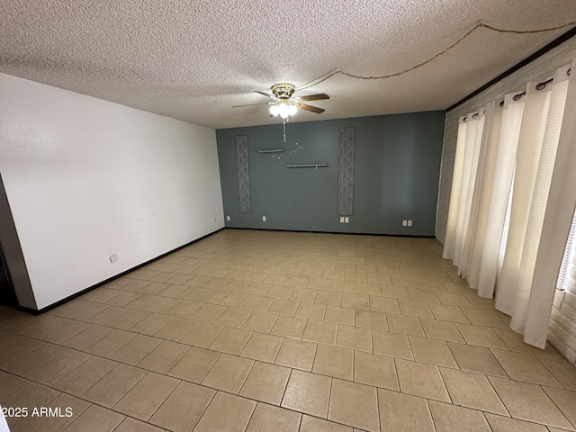 220 S Old Litchfield Rd Unit 104, Litchfield Park, AZ 85340 - empty room featuring a ceiling fan, a textured ceiling, and baseboards