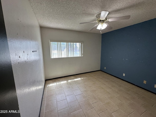 220 S Old Litchfield Rd Unit 104, Litchfield Park, AZ 85340 - spare room with a ceiling fan, a textured ceiling, baseboards, and tile patterned flooring