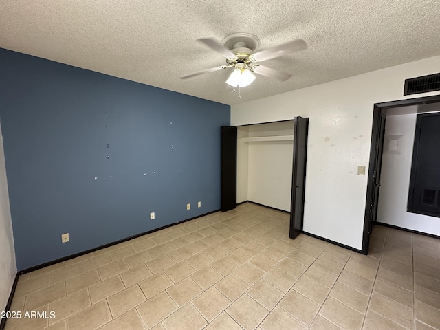 220 S Old Litchfield Rd Unit 104, Litchfield Park, AZ 85340 - unfurnished bedroom with a textured ceiling, light tile patterned flooring, ceiling fan, and baseboards