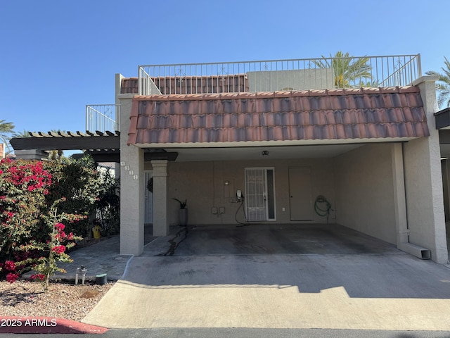 view of parking featuring a carport and concrete driveway