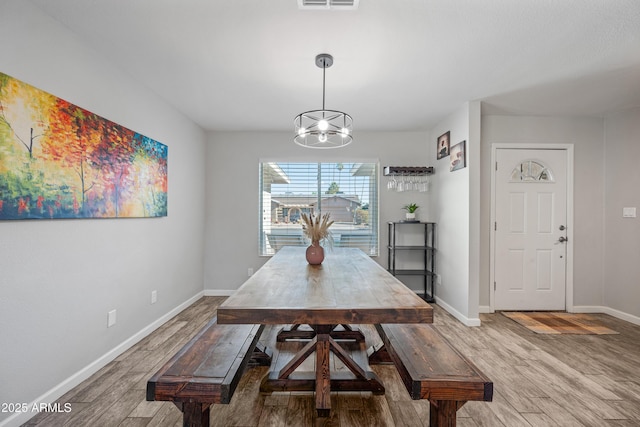 dining room with a notable chandelier and hardwood / wood-style flooring