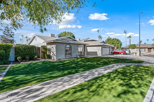 view of front of house featuring a garage and a front lawn