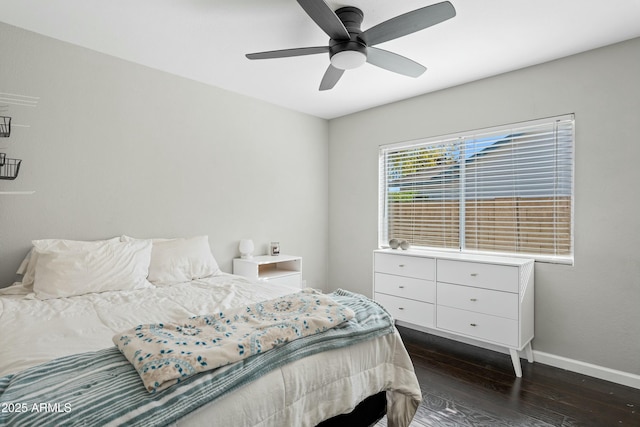 bedroom with dark hardwood / wood-style flooring and ceiling fan