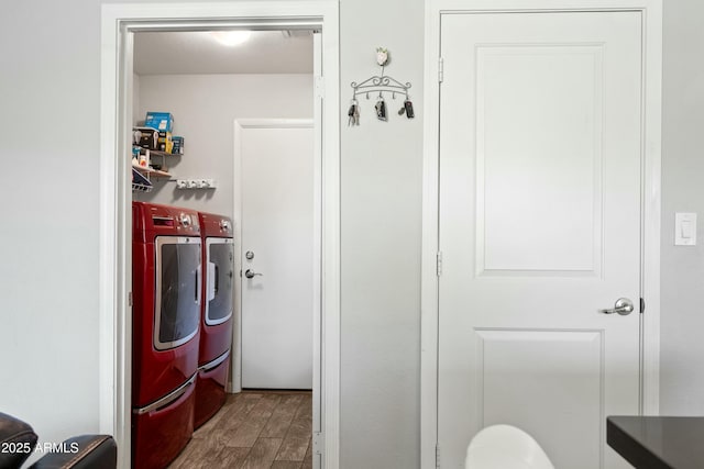 laundry area featuring hardwood / wood-style flooring and washing machine and clothes dryer