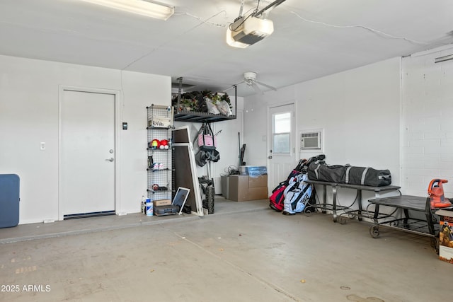 garage with a garage door opener and a wall unit AC