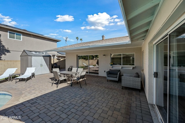 view of patio featuring a storage shed and an outdoor living space