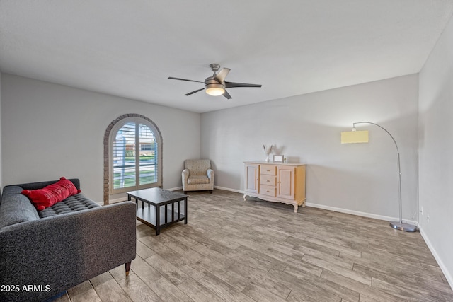 living area with ceiling fan and light wood-type flooring