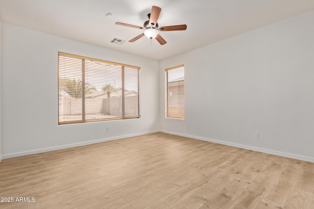 2590 S Buckaroo Trl, Gilbert, AZ 85295 - spare room featuring ceiling fan, light wood finished floors, and baseboards