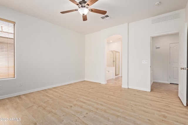2590 S Buckaroo Trl, Gilbert, AZ 85295 - empty room with ceiling fan, light wood-type flooring, arched walkways, baseboards, and a smoke detector