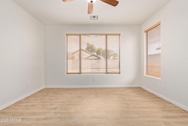2590 S Buckaroo Trl, Gilbert, AZ 85295 - spare room featuring light wood-style flooring, ceiling fan, and baseboards