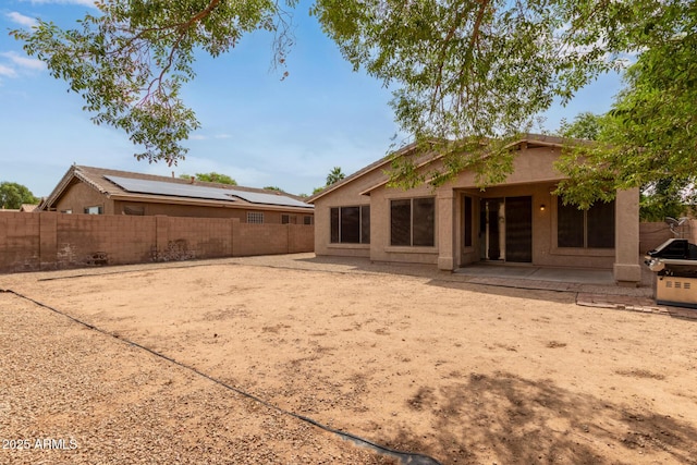 2590 S Buckaroo Trl, Gilbert, AZ 85295 - back of house featuring a fenced backyard, a patio area, and stucco siding