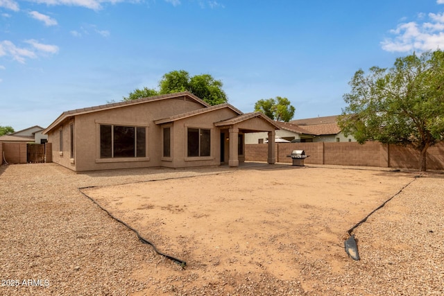 2590 S Buckaroo Trl, Gilbert, AZ 85295 - back of house with stucco siding, a fenced backyard, and a patio area