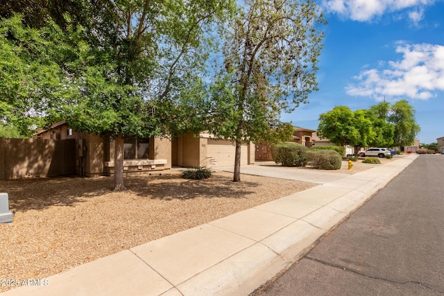 2590 S Buckaroo Trl, Gilbert, AZ 85295 - view of front of home with concrete driveway, stucco siding, and a garage