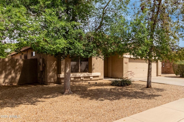 2590 S Buckaroo Trl, Gilbert, AZ 85295 - view of front facade with concrete driveway and stucco siding