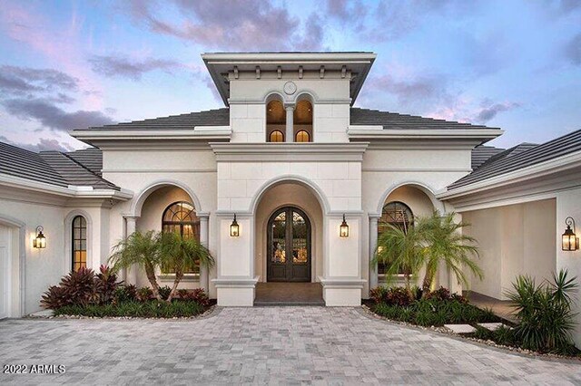 exterior entry at dusk with a garage