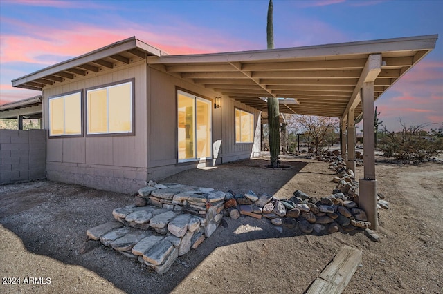 view of back house at dusk