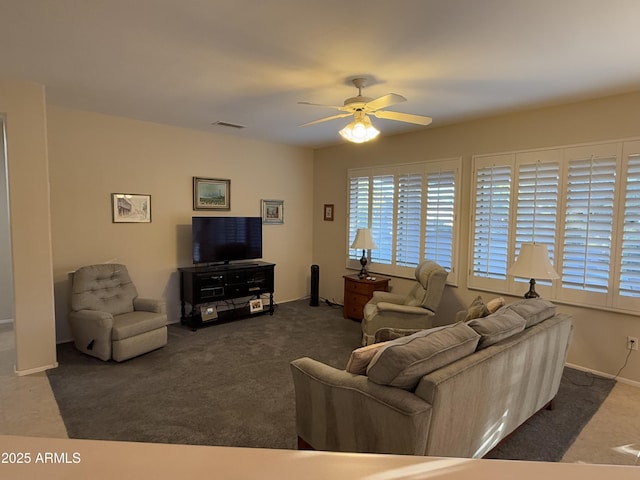 living room with ceiling fan and dark carpet